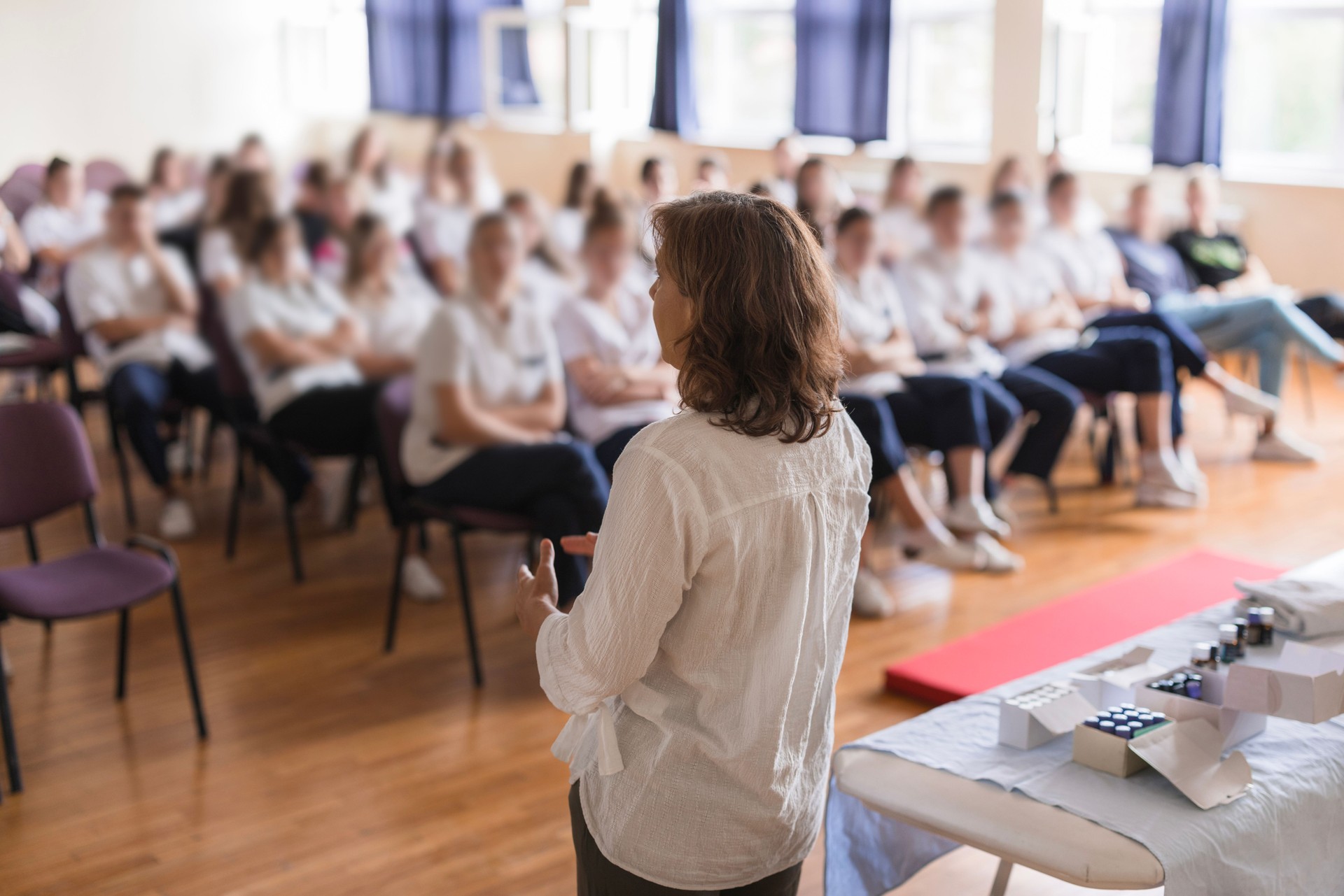 Rear-view of a woman having a lecture