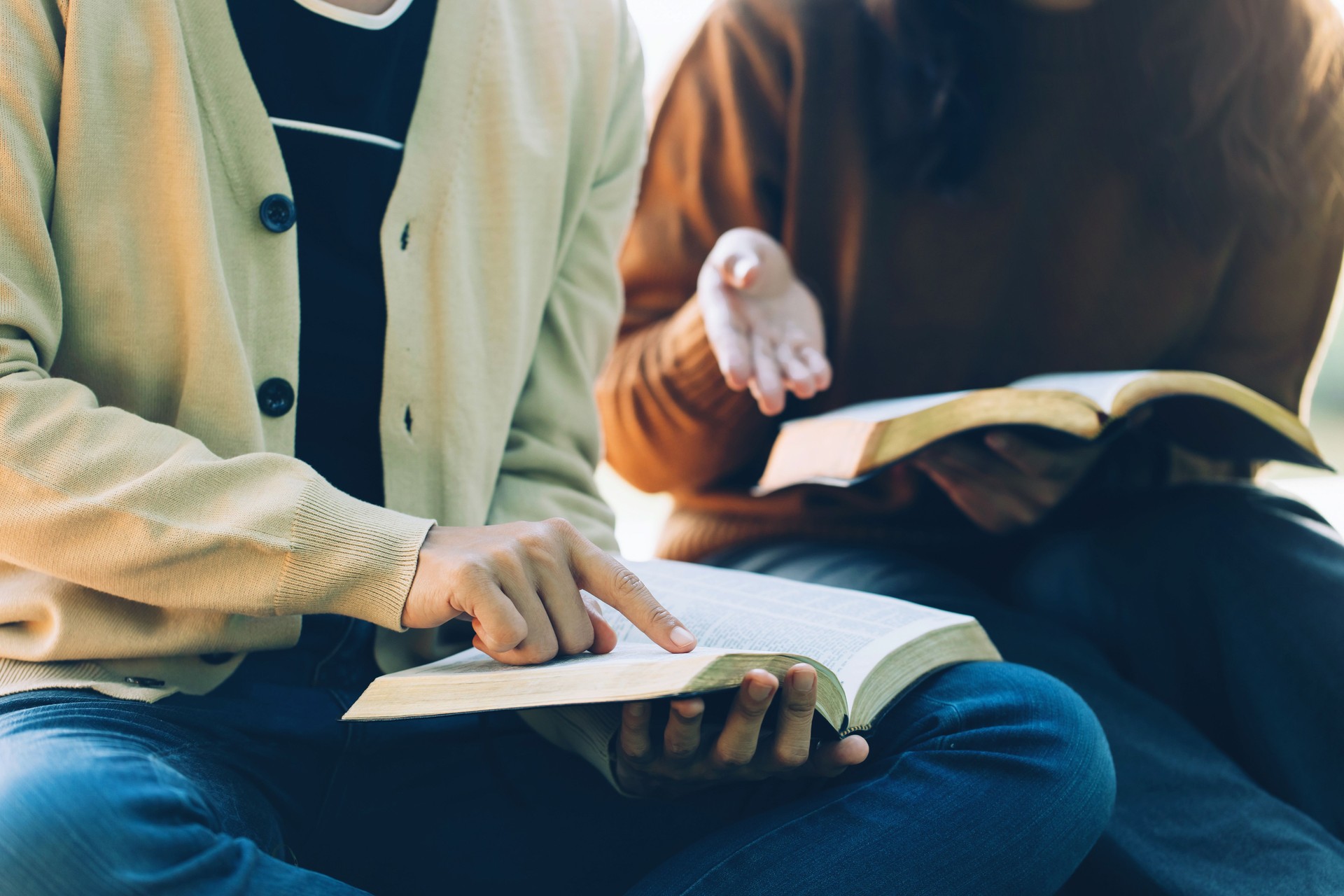 Christian Bible Study Concepts. Christian friends read and study the bible together in the park. followers are studying the word of God in churches. sharing the gospel with a friend. Education